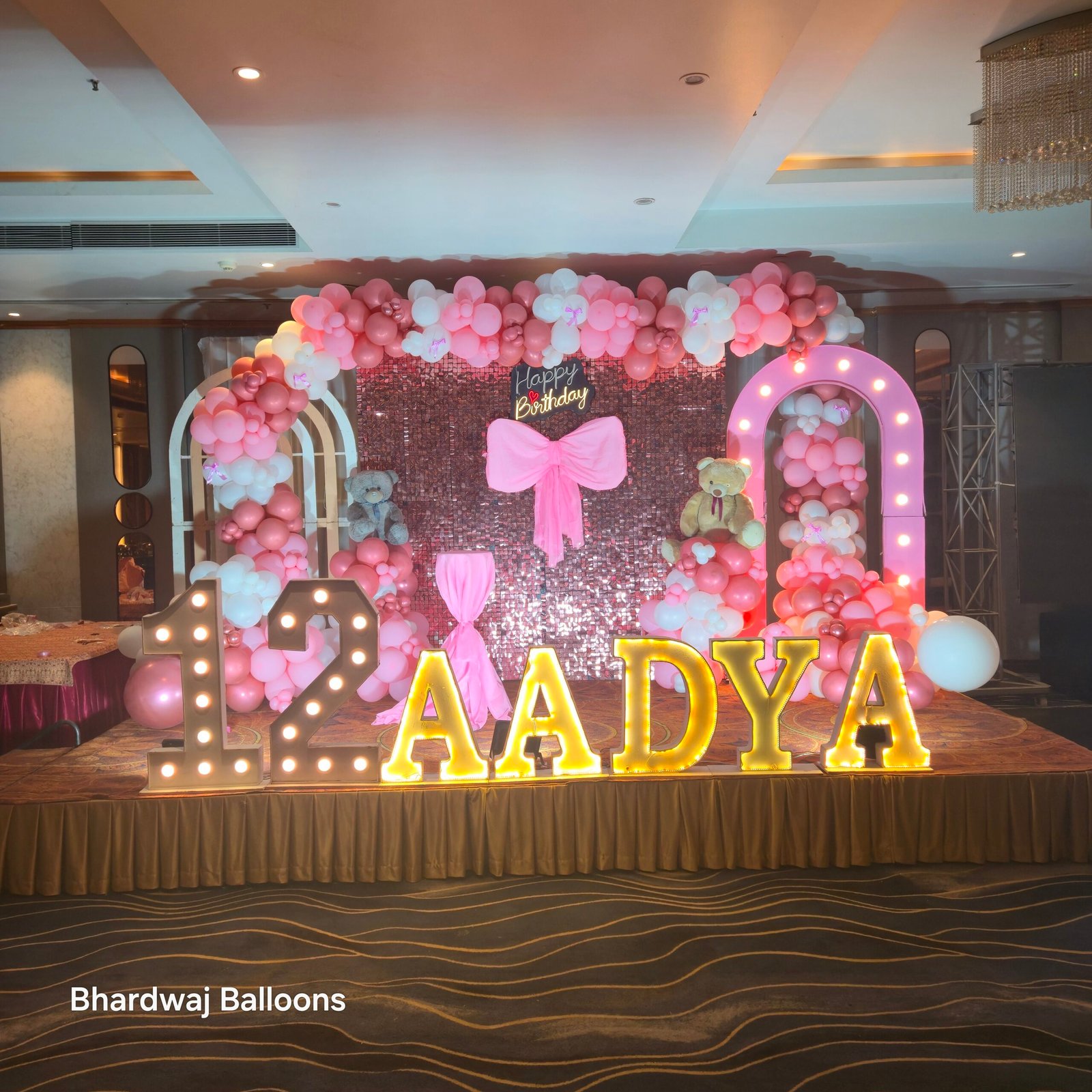 Pink Theme Birthday Stage Decoration with Golden Balloons, Decorative Ribbons, Pink Backdrop and Elegant Party Decor