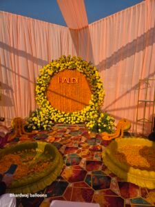 Haldi Ceremony Decoration with Yellow Flowers, Marigold Backdrop and Traditional Stage Setup